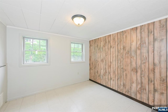 16 Murray Rd, Montvale, NJ 07645 - spare room featuring ornamental molding, tile patterned floors, and wood walls