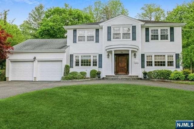 74 O Shaughnessy Ln, Closter, NJ 07624 - view of front of house featuring a garage, driveway, and a front yard