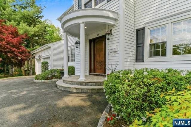 74 O Shaughnessy Ln, Closter, NJ 07624 - doorway to property featuring a garage