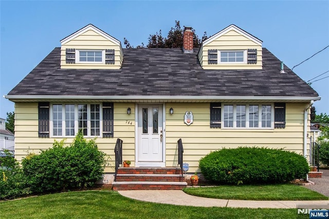 744 9th St, Carlstadt, NJ 07072 - cape cod home with a chimney, a shingled roof, a front yard, and entry steps