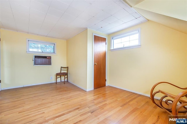 744 9th St, Carlstadt, NJ 07072 - living area with an AC wall unit, light wood-style flooring, and plenty of natural light