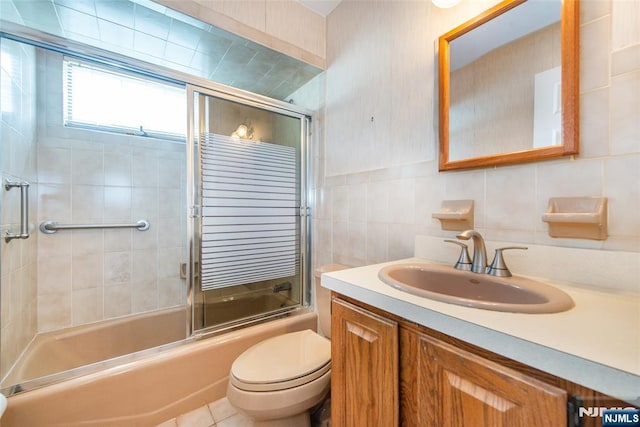 744 9th St, Carlstadt, NJ 07072 - full bath with vanity, combined bath / shower with glass door, tile walls, and tile patterned floors