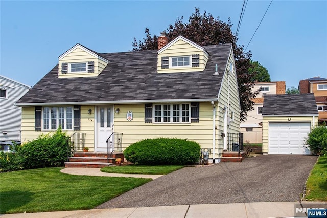 744 9th St, Carlstadt, NJ 07072 - new england style home featuring a front yard, roof with shingles, a chimney, driveway, and a garage