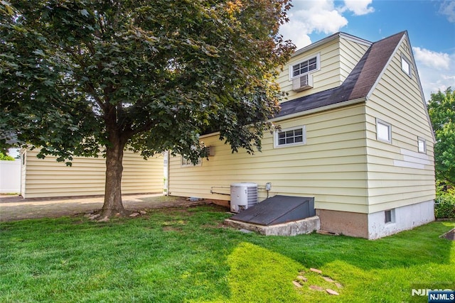 744 9th St, Carlstadt, NJ 07072 - view of side of property with a yard, roof with shingles, and cooling unit