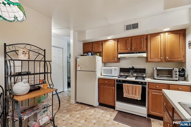 1907 Faulkner Ct, Mahwah, NJ 07430 - kitchen featuring white appliances, under cabinet range hood, light countertops, and brown cabinets