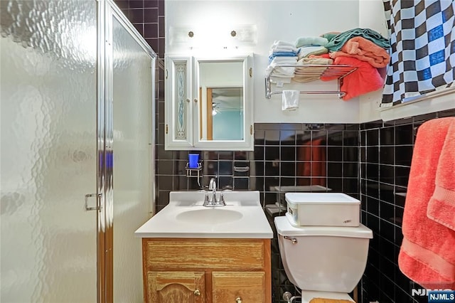 28 Urma Pl, Bloomfield, NJ 07003 - full bathroom with a stall shower, vanity, tile walls, and a ceiling fan