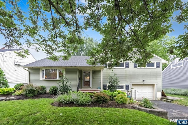 28 Urma Pl, Bloomfield, NJ 07003 - split level home with asphalt driveway, an attached garage, and a front lawn