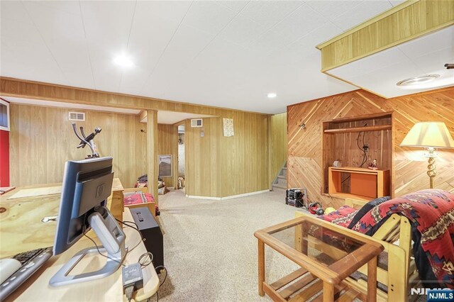 28 Urma Pl, Bloomfield, NJ 07003 - living area with wooden walls, carpet flooring, and stairway