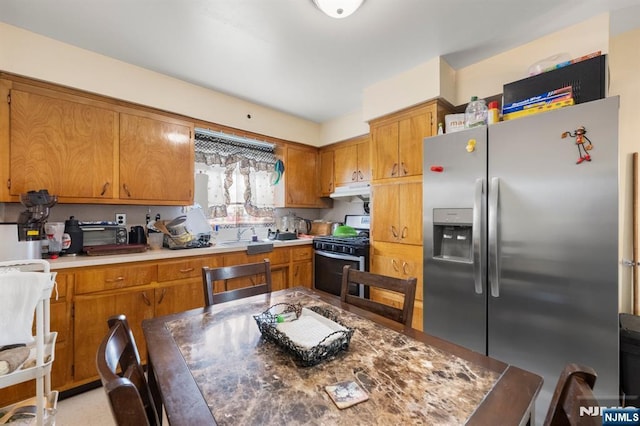 105 Old Hoboken Rd, Hackensack, NJ 07601 - kitchen featuring appliances with stainless steel finishes, under cabinet range hood, brown cabinets, and light countertops