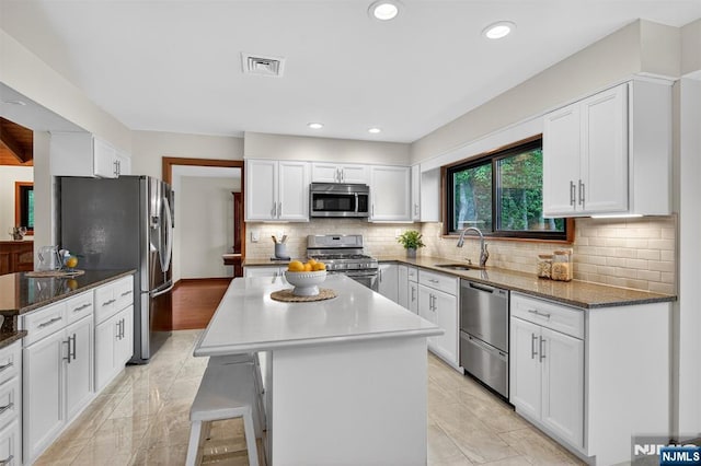 11 Country Ln, Mahwah, NJ 07430 - kitchen featuring appliances with stainless steel finishes, white cabinets, a center island, backsplash, and recessed lighting