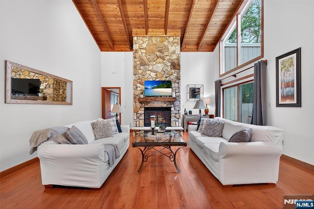 11 Country Ln, Mahwah, NJ 07430 - living area featuring a wood ceiling with exposed beams, a stone fireplace, high vaulted ceiling, and wood finished floors