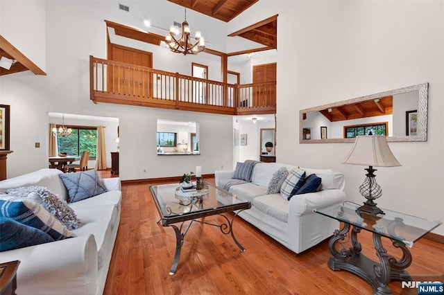11 Country Ln, Mahwah, NJ 07430 - living room with a chandelier, high vaulted ceiling, wood finished floors, and a wood ceiling with exposed beams