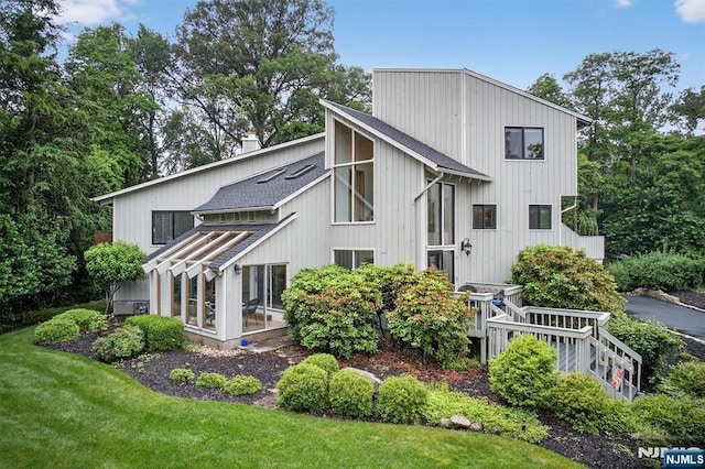 11 Country Ln, Mahwah, NJ 07430 - back of property with a shingled roof, a chimney, and a yard