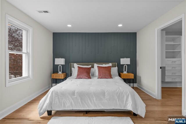 222 4th St, Ridgefield Park, NJ 07660 - bedroom featuring an accent wall, recessed lighting, and wood finished floors