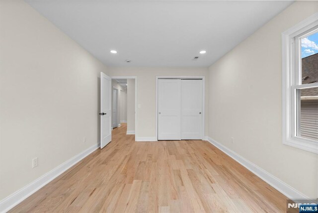 222 4th St, Ridgefield Park, NJ 07660 - unfurnished bedroom with light wood-style flooring, recessed lighting, and a closet