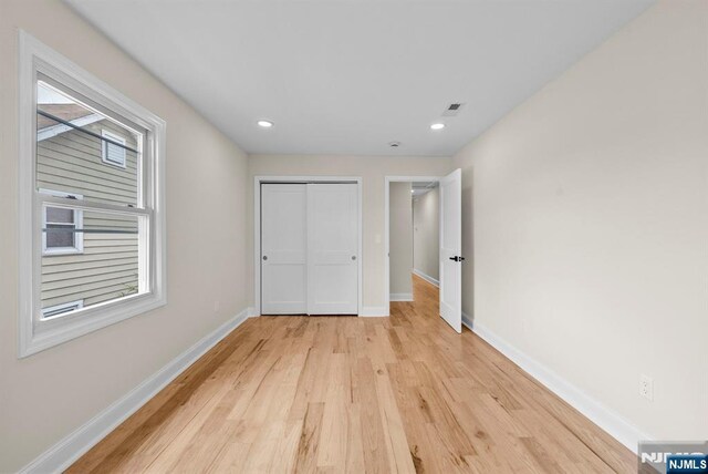 222 4th St, Ridgefield Park, NJ 07660 - unfurnished bedroom with light wood finished floors, a closet, and recessed lighting