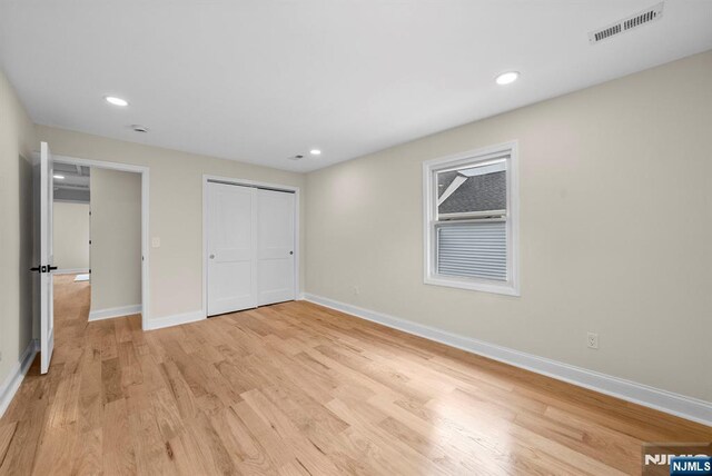 222 4th St, Ridgefield Park, NJ 07660 - unfurnished bedroom with light wood finished floors, a closet, and recessed lighting