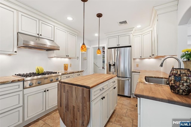 21 Valley Forge Way, Ho-Ho-Kus, NJ 07423 - kitchen with appliances with stainless steel finishes, wooden counters, under cabinet range hood, arched walkways, and a kitchen island