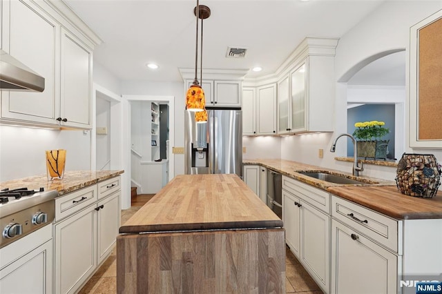21 Valley Forge Way, Ho-Ho-Kus, NJ 07423 - kitchen featuring appliances with stainless steel finishes, wood counters, arched walkways, hanging light fixtures, and recessed lighting