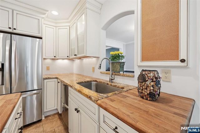 21 Valley Forge Way, Ho-Ho-Kus, NJ 07423 - kitchen with stainless steel fridge, butcher block countertops, arched walkways, glass insert cabinets, and white cabinets
