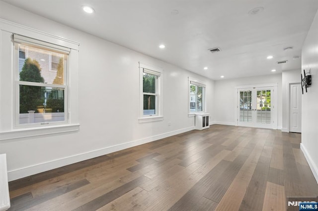 26 Amsterdam Ave, Teaneck, NJ 07666 - unfurnished living room with hardwood / wood-style flooring and recessed lighting