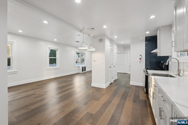 26 Amsterdam Ave, Teaneck, NJ 07666 - kitchen with light stone countertops, dark wood-type flooring, recessed lighting, tasteful backsplash, and open floor plan