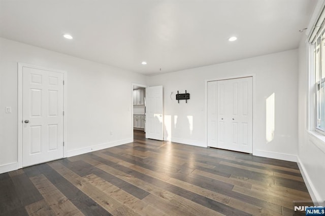 26 Amsterdam Ave, Teaneck, NJ 07666 - unfurnished bedroom featuring dark wood finished floors, recessed lighting, and multiple windows