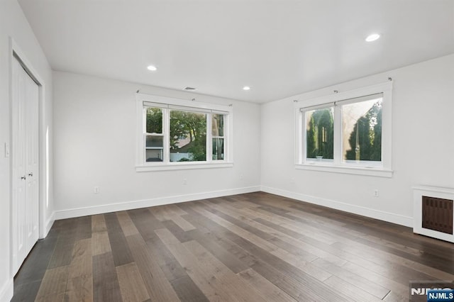 26 Amsterdam Ave, Teaneck, NJ 07666 - unfurnished bedroom with multiple windows, dark wood-style floors, a closet, and recessed lighting