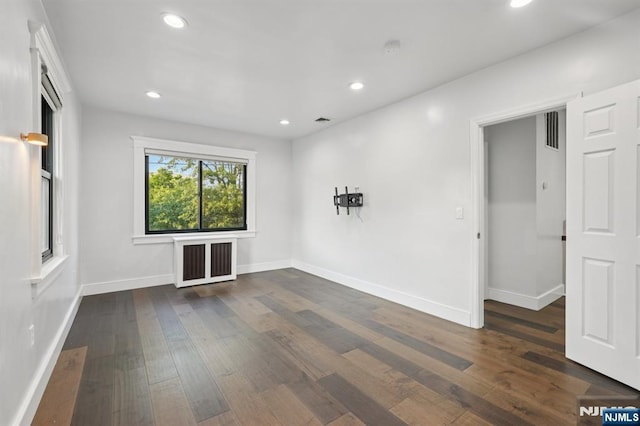 26 Amsterdam Ave, Teaneck, NJ 07666 - unfurnished room with dark wood-type flooring, recessed lighting, radiator, and a smoke detector