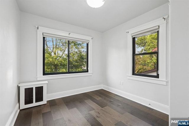 26 Amsterdam Ave, Teaneck, NJ 07666 - unfurnished room with dark wood-style flooring and baseboards