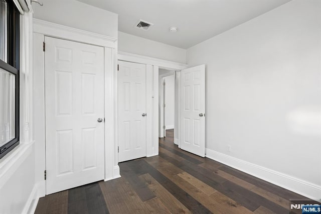 26 Amsterdam Ave, Teaneck, NJ 07666 - unfurnished bedroom featuring dark wood-style flooring and baseboards