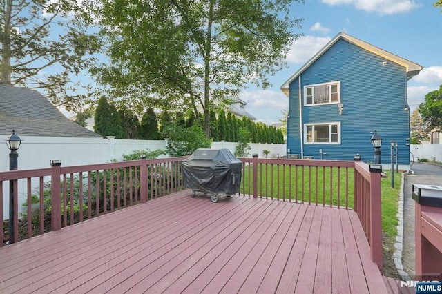 26 Amsterdam Ave, Teaneck, NJ 07666 - wooden deck with area for grilling and a fenced backyard