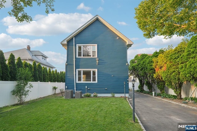 26 Amsterdam Ave, Teaneck, NJ 07666 - view of home's exterior with a fenced backyard and a central air condition unit