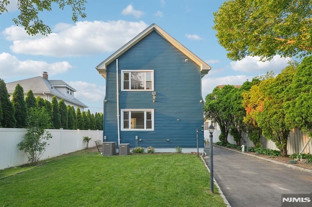 26 Amsterdam Ave, Teaneck, NJ 07666 - view of side of home with a fenced backyard and a cooling unit