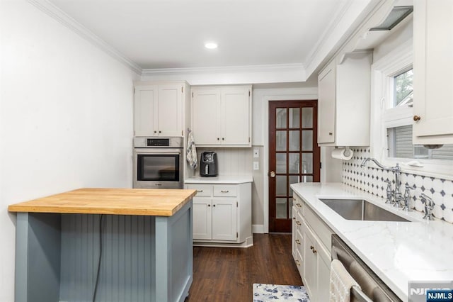 286 Willow Ave, Lyndhurst, NJ 07071 - kitchen with stainless steel appliances, tasteful backsplash, dark wood finished floors, wooden counters, and crown molding