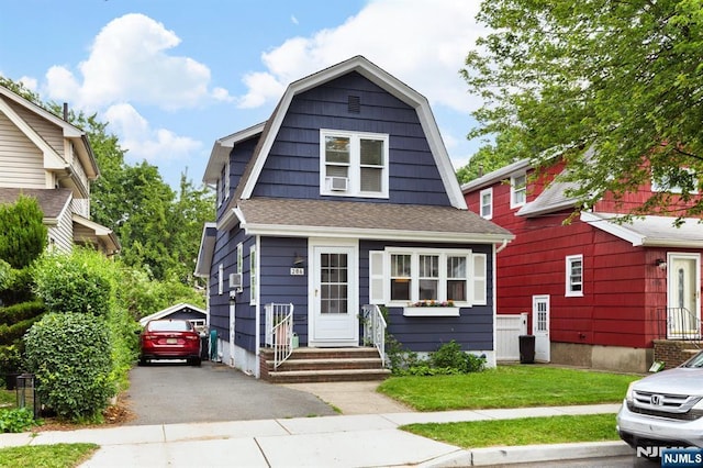 286 Willow Ave, Lyndhurst, NJ 07071 - dutch colonial featuring a gambrel roof, entry steps, driveway, a shingled roof, and a front yard