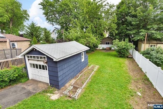 286 Willow Ave, Lyndhurst, NJ 07071 - fenced backyard featuring an outdoor structure and a detached garage