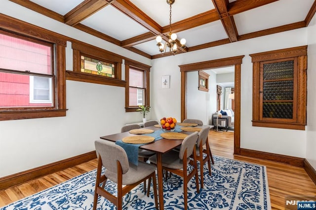 286 Willow Ave, Lyndhurst, NJ 07071 - dining room featuring healthy amount of natural light, a chandelier, coffered ceiling, light wood-style floors, and beam ceiling