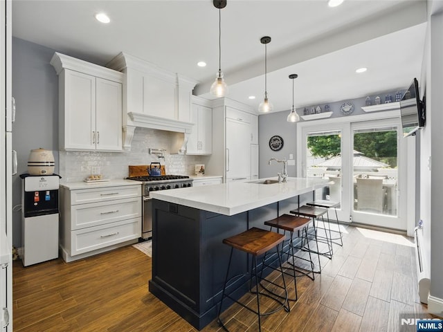 36 First, Hawthorne, NJ 07506 - kitchen with stainless steel stove, white cabinetry, light countertops, recessed lighting, and decorative backsplash
