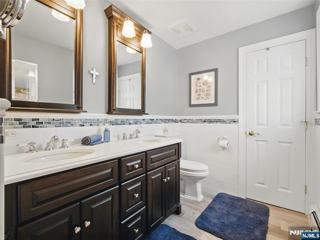 36 First, Hawthorne, NJ 07506 - full bath with double vanity, tile walls, wood finished floors, wainscoting, and a baseboard heating unit