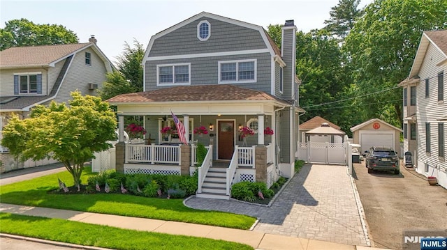 36 First, Hawthorne, NJ 07506 - view of front of house featuring a gambrel roof, covered porch, a garage, an outbuilding, and a chimney