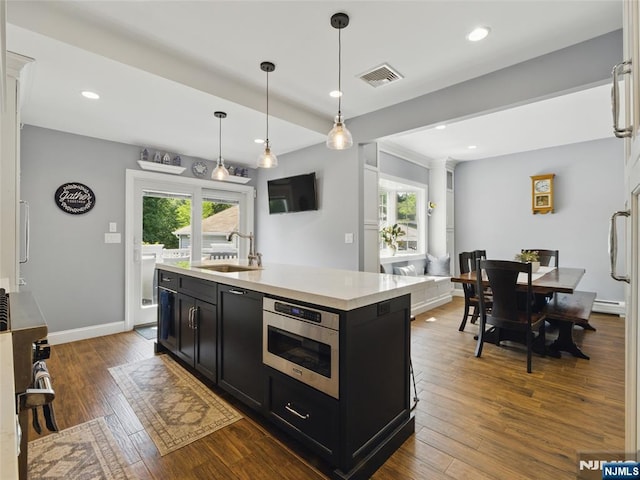 36 First, Hawthorne, NJ 07506 - kitchen with dark cabinetry, light countertops, dark wood-type flooring, recessed lighting, and hanging light fixtures