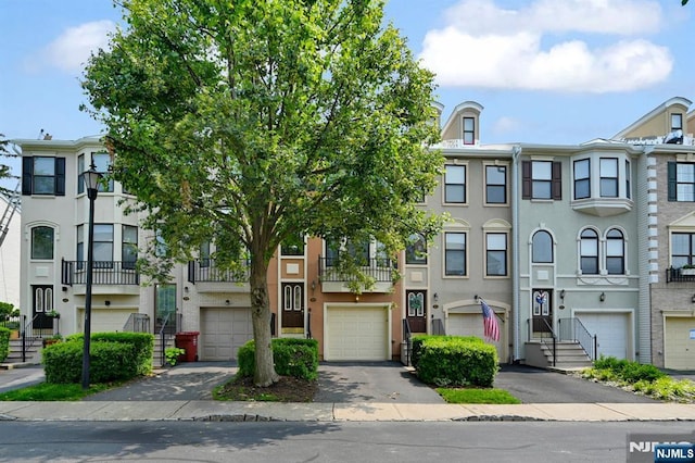 303 Wilshire Dr, Nutley, NJ 07110 - multi unit property with a garage, driveway, and stucco siding