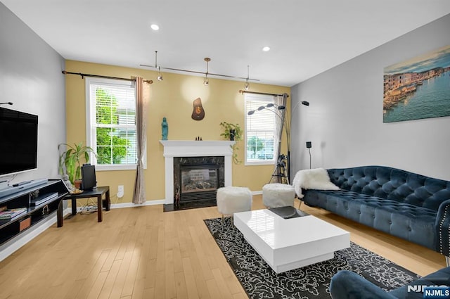 303 Wilshire Dr, Nutley, NJ 07110 - living area featuring healthy amount of natural light, a high end fireplace, light wood finished floors, and recessed lighting