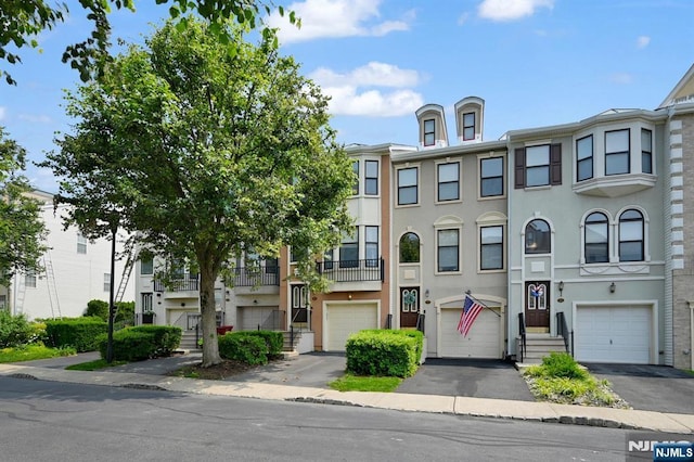 303 Wilshire Dr, Nutley, NJ 07110 - multi unit property featuring stucco siding, driveway, and an attached garage