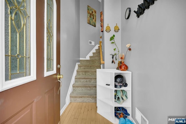 303 Wilshire Dr, Nutley, NJ 07110 - foyer entrance with stairway and light wood-style floors