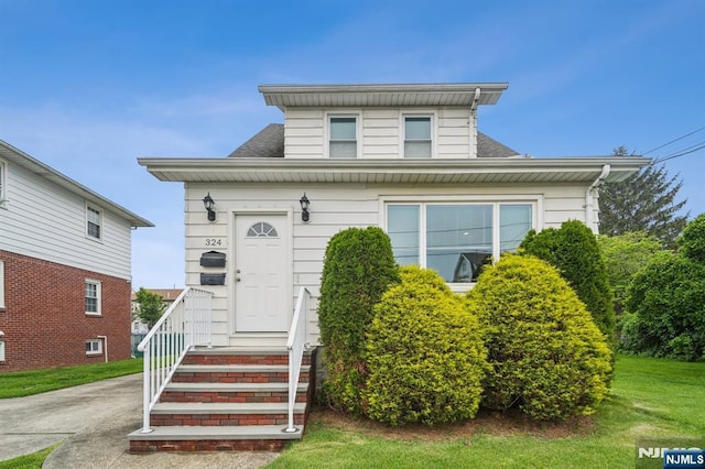 322 3rd St, Saddle Brook, NJ 07663 - view of front facade with a front yard and a shingled roof