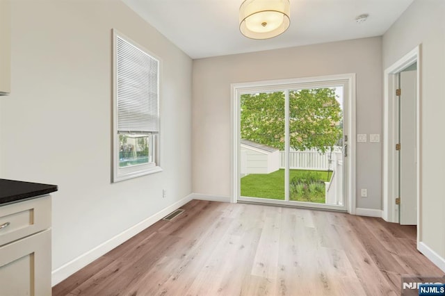 322 3rd St, Saddle Brook, NJ 07663 - unfurnished dining area with light wood-style flooring and baseboards