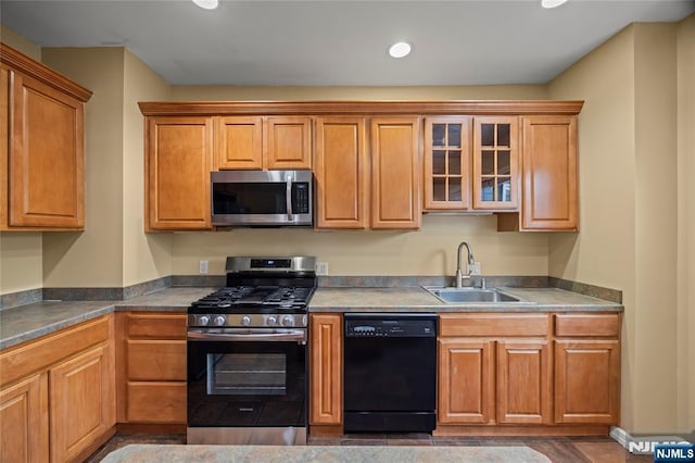 115 12th St, Prospect Park, NJ 07508 - kitchen with appliances with stainless steel finishes, glass insert cabinets, recessed lighting, and brown cabinets