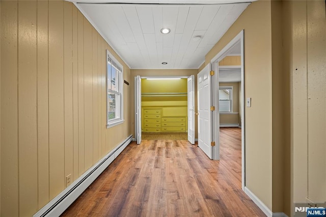 115 12th St, Prospect Park, NJ 07508 - hallway with baseboard heating, wood finished floors, and wood walls